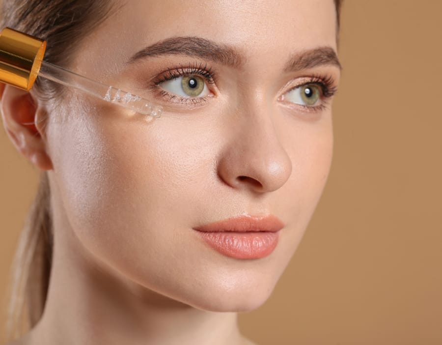 Serum dropper applied at the cheekbone
